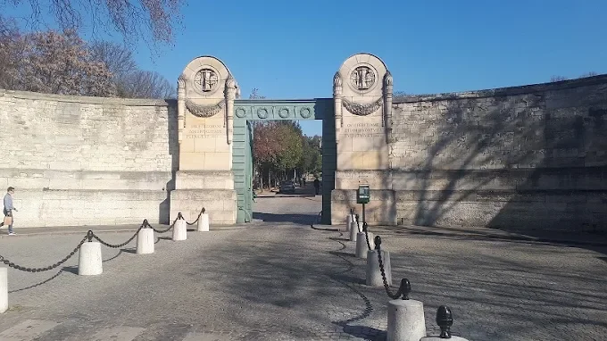 Pere Lachaise Cemetery in Paris, France, with tree-lined cobblestone paths and ornate mausoleums